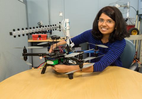 photo of person working on a drone on a table