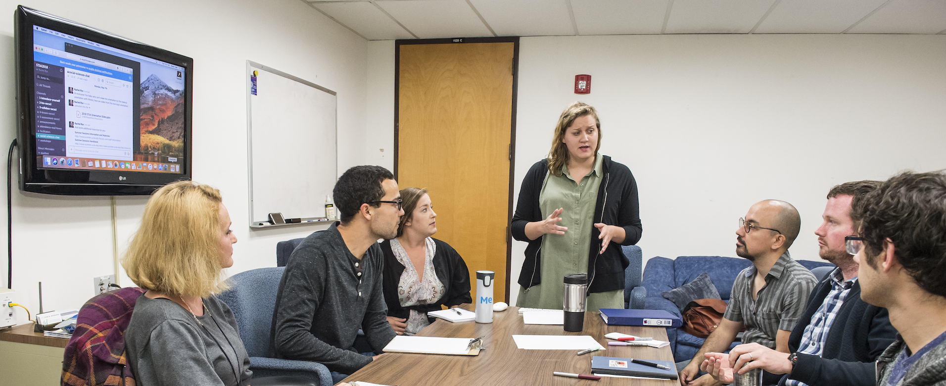 photo of six people in a conference room holding a meeting