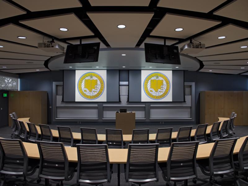 photo of two rows of semicircular tables facing a lectern