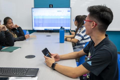 photo of students having a meeting at a conference table